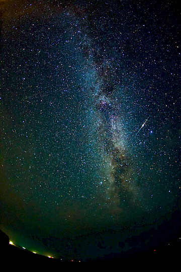 The Milky Way above Porth Nanven, Cornwall, with an Iridium flare.